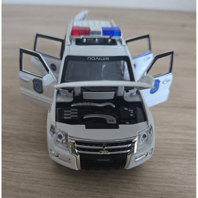Машина металева поліція Mitsubishi Авто Експерт 1:32 світло звук інерція відч двері баг капот 15*6*6,5см (51282)